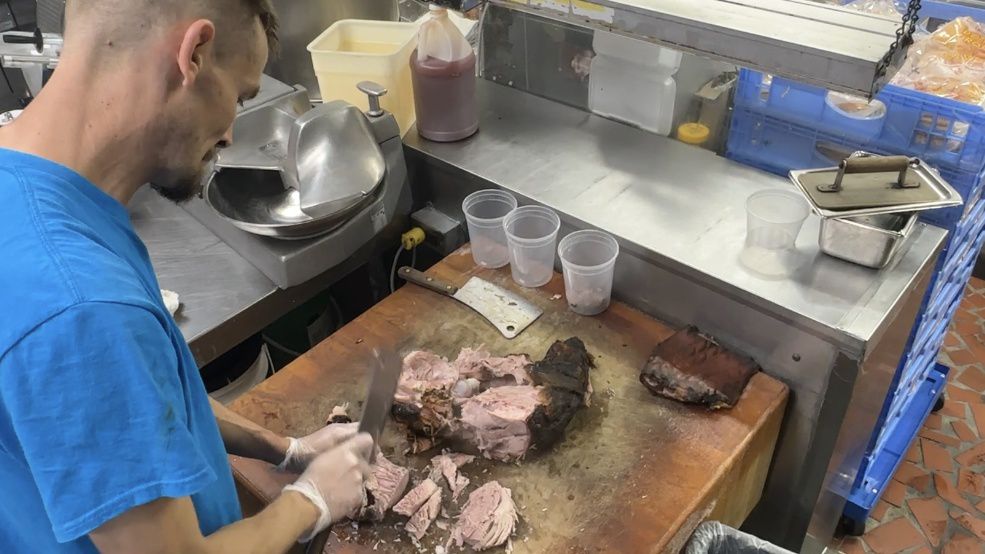 Eric Kimbrell chopping meat.